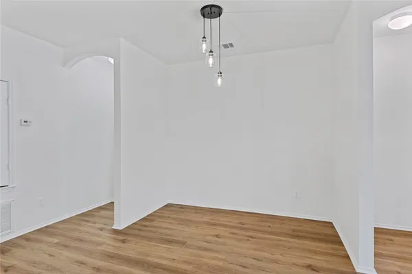 a view of a kitchen with wooden floor and a ceiling fan