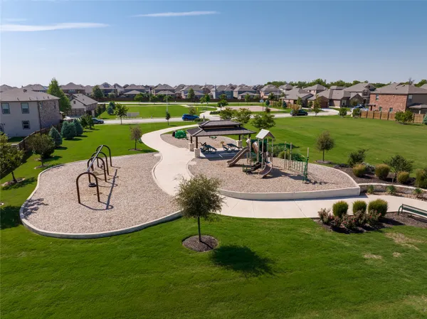 an aerial view of a city with lots of residential buildings ocean and mountain view in back