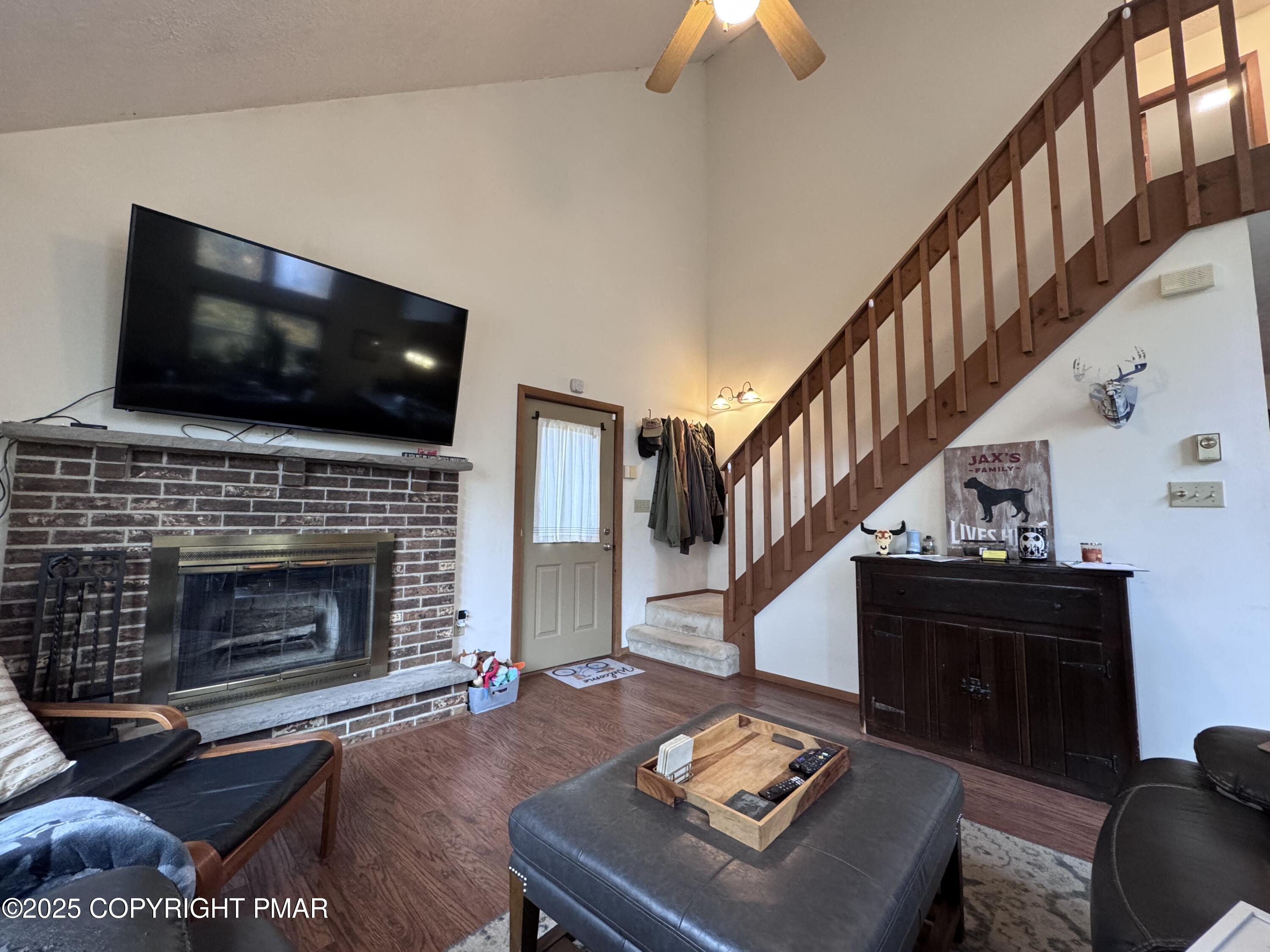 67 Seneca Road Albrightsville, PA 18210 - Photo 11 of 52 a living room with furniture a flat screen tv and a fireplace