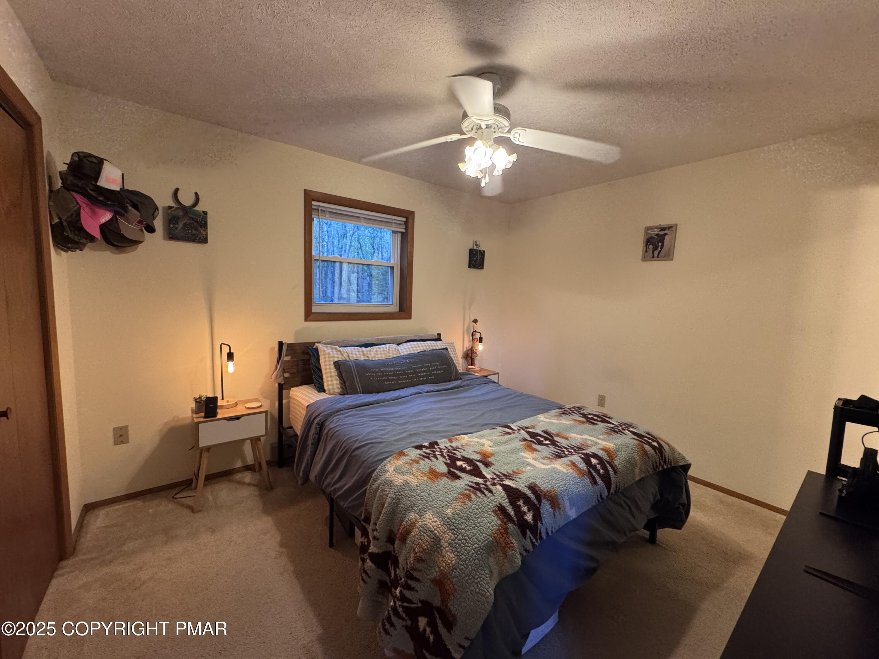 67 Seneca Road Albrightsville, PA 18210 - Photo 16 of 52 a bedroom with a bed and a chandelier