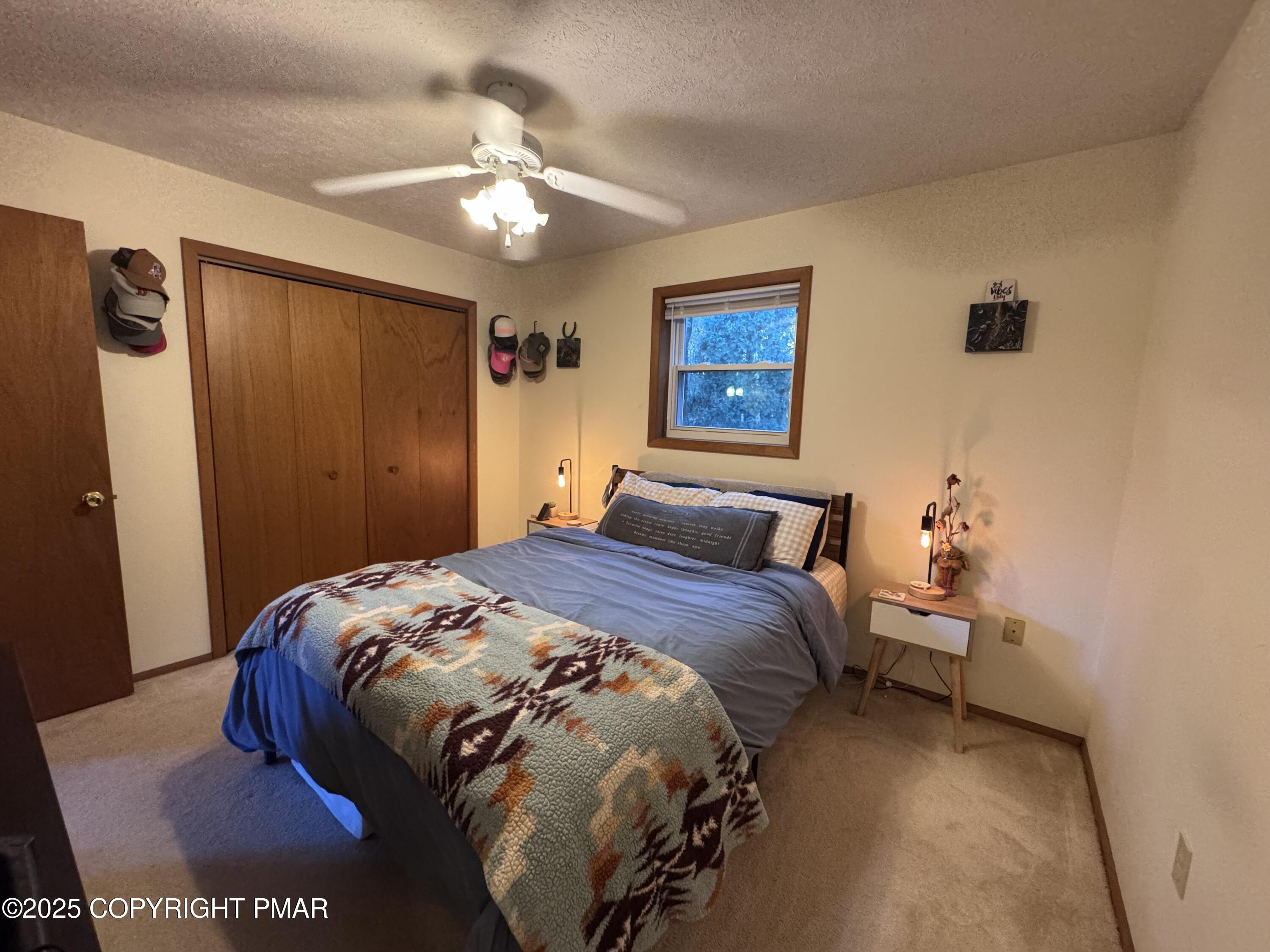 67 Seneca Road Albrightsville, PA 18210 - Photo 19 of 52 a bedroom with a bed and a chandelier