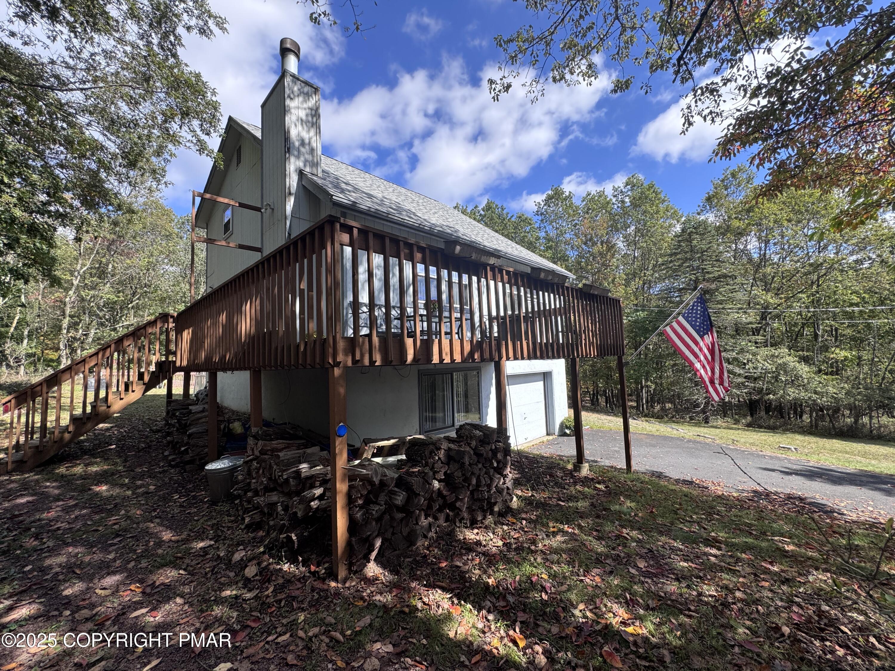 67 Seneca Road Albrightsville, PA 18210 - Photo 2 of 52 a view of house with wooden stairs and a tree