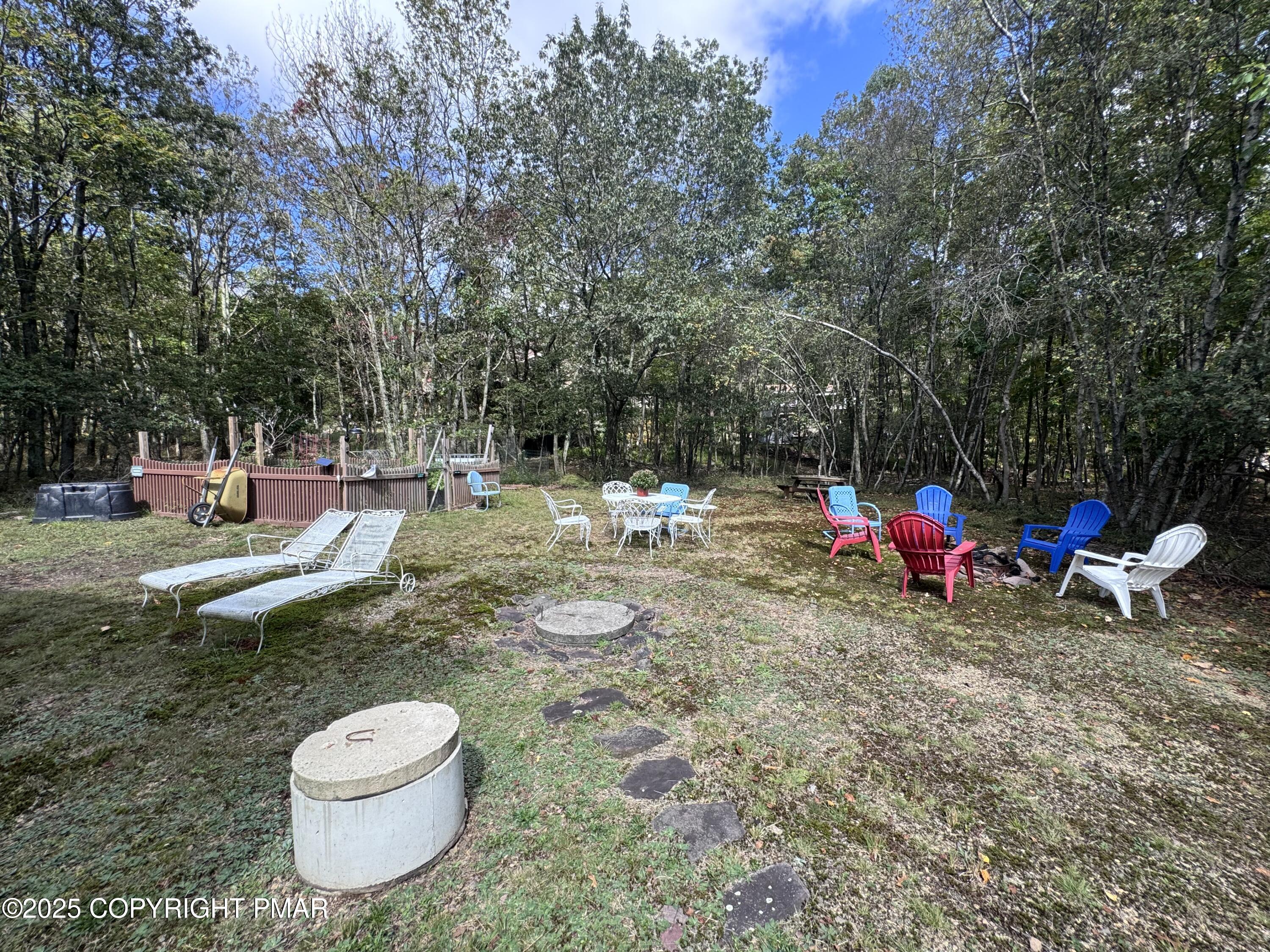 67 Seneca Road Albrightsville, PA 18210 - Photo 46 of 52 a view of a backyard with table and chairs and a fire pit