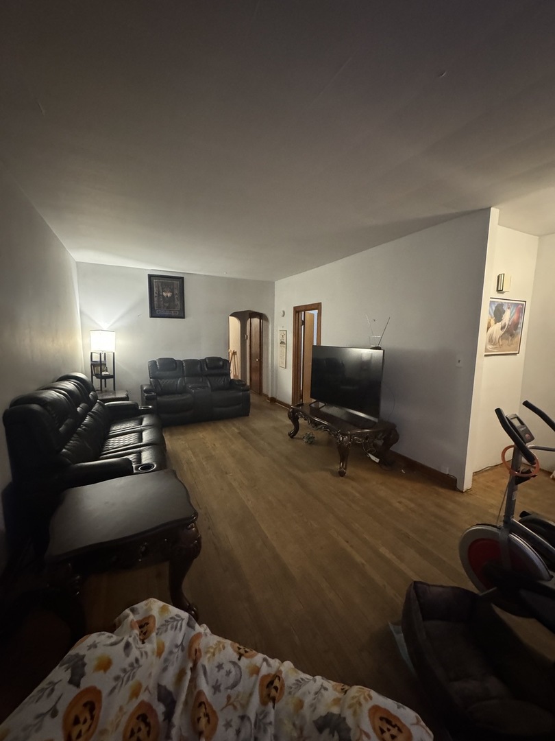 3945 West 55th Place Chicago, IL 60629 - Photo 3 of 21 a bedroom with furniture and a wooden floor