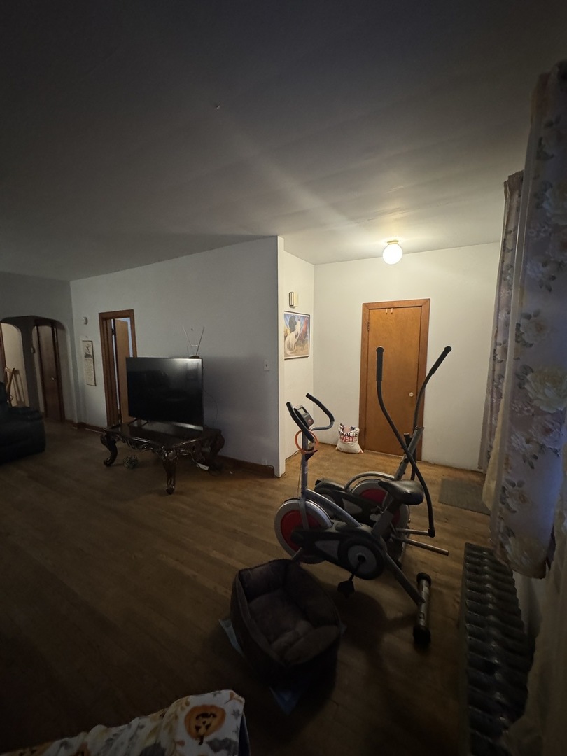 3945 West 55th Place Chicago, IL 60629 - Photo 4 of 21 a view of a workspace with furniture and gym cycle