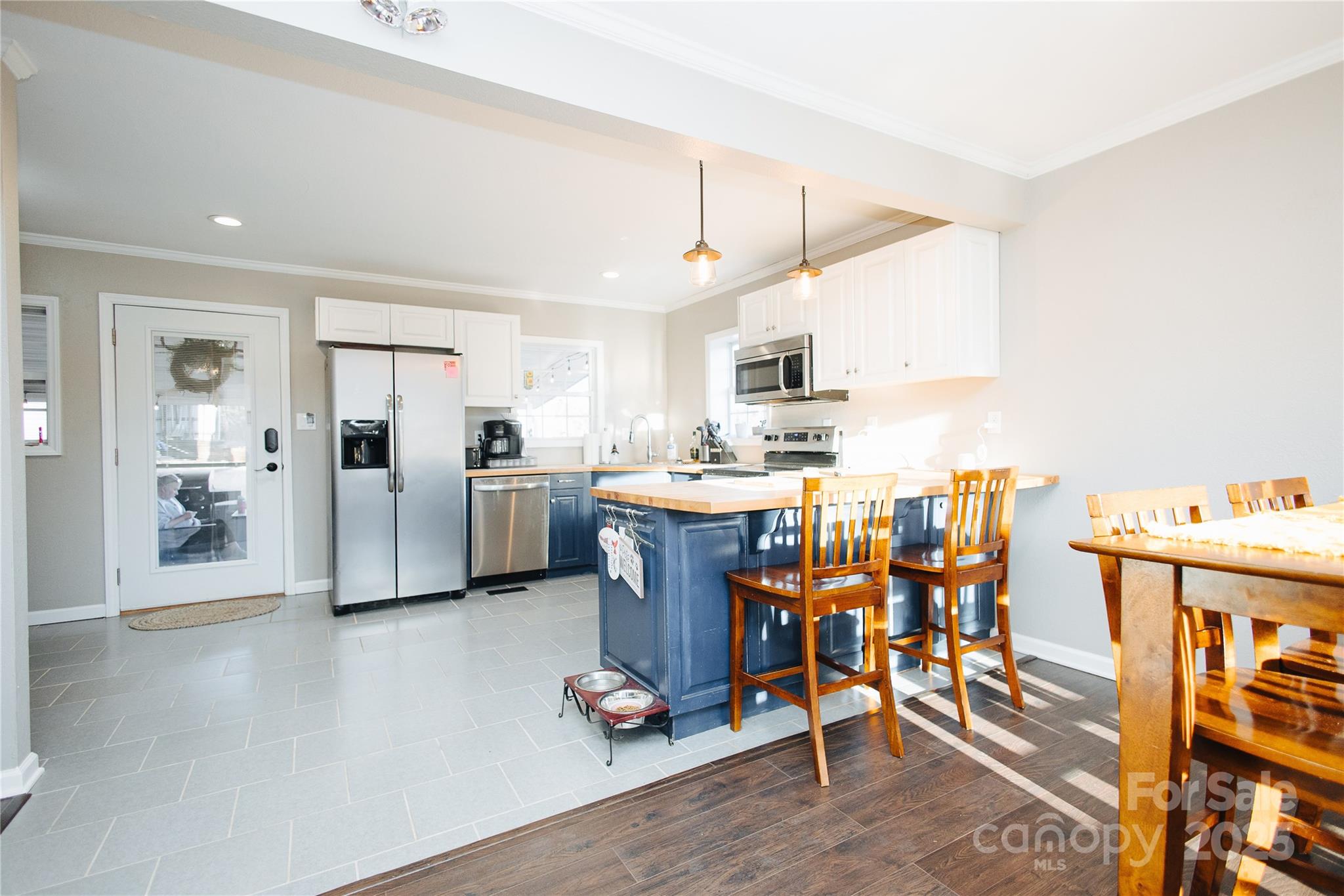 530 Toney Road Marion, NC 28752 - Photo 27 of 48 a kitchen with stainless steel appliances kitchen island granite countertop a refrigerator oven a sink dishwasher and white cabinets with wooden floor