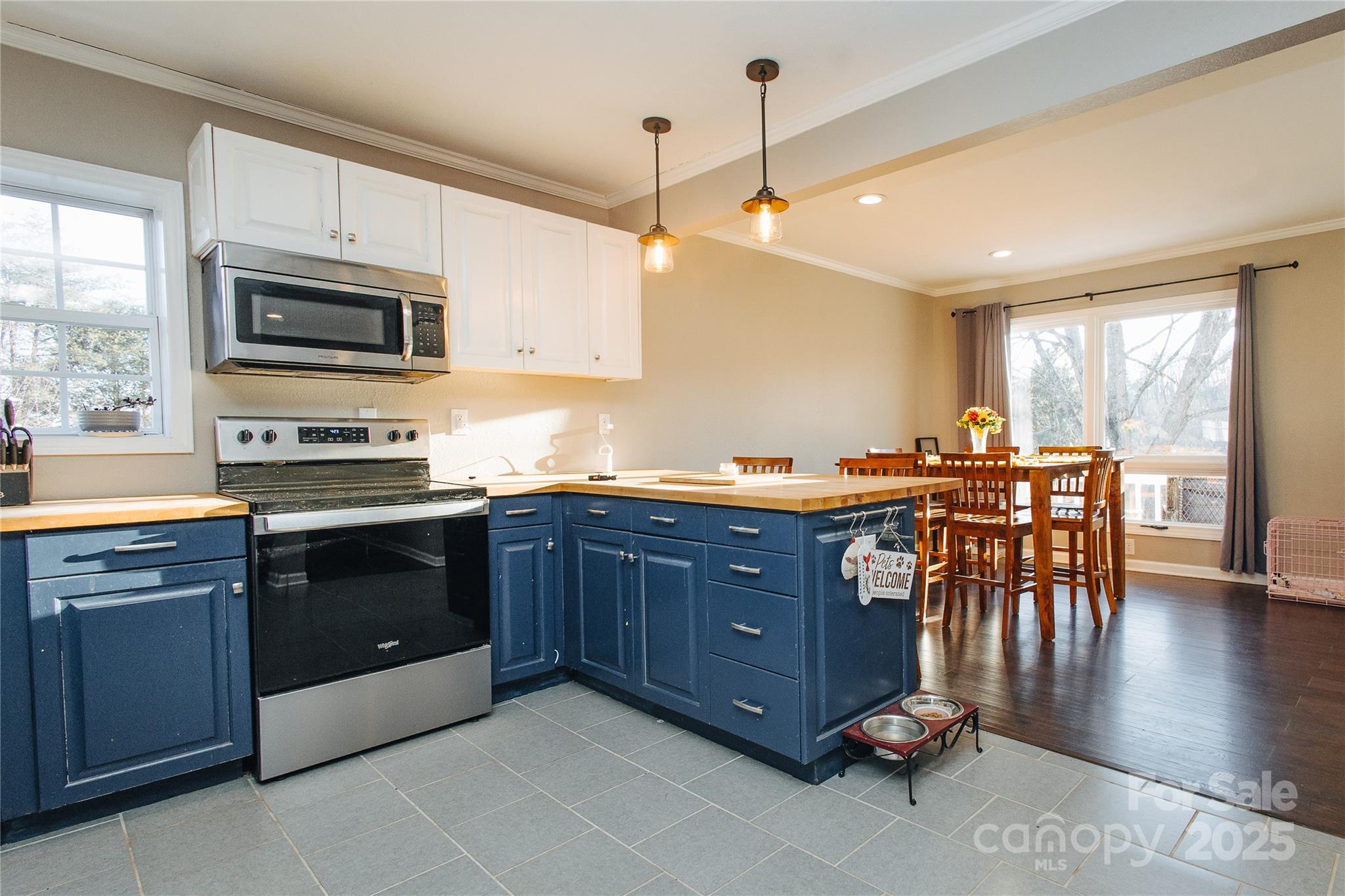 530 Toney Road Marion, NC 28752 - Photo 33 of 48 a kitchen with stainless steel appliances granite countertop a stove top oven a sink dishwasher a dining table and chairs with wooden floor