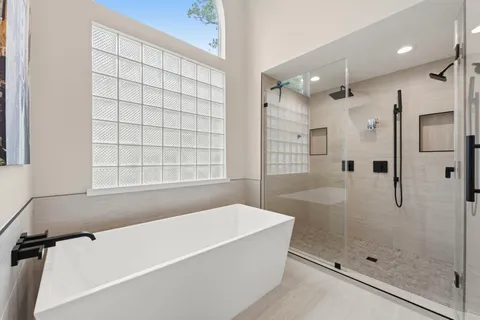 a bathroom with a bathtub and shower
