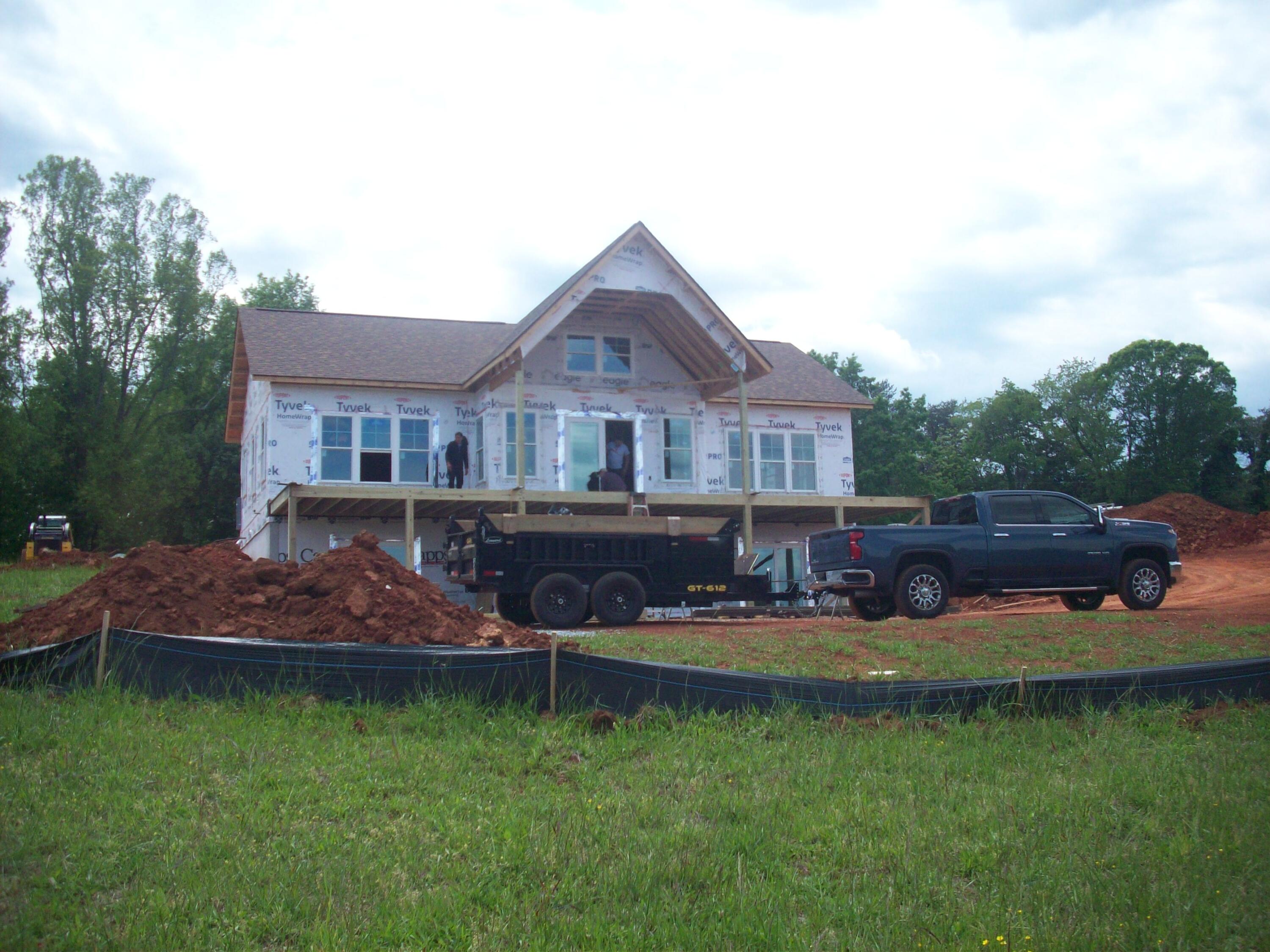 6990 Horseshoe Bend Road Goodview, VA 24095 - Photo 2 of 18 a front view of a house with a garden and swimming pool