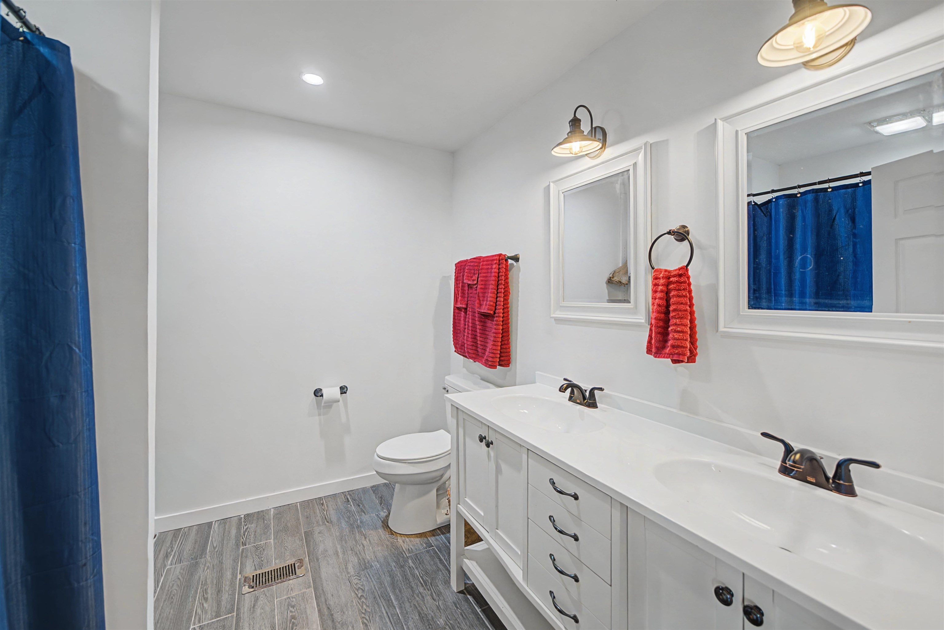 7010 22nd Highway Adamsville, TN 38310 - Photo 13 of 33 Bathroom with curtained shower, wood tiled floors, double vanity, and recessed lighting