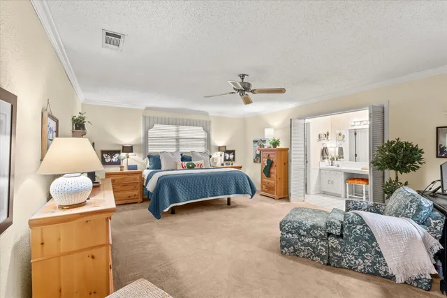 a spacious bedroom with a bed and ceiling fan