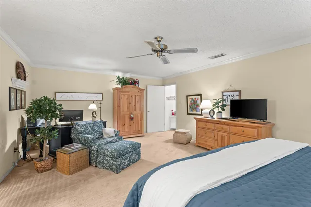 a bedroom with furniture and a flat screen tv