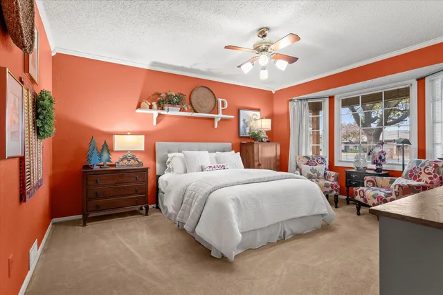 a spacious bedroom with a bed and a chandelier