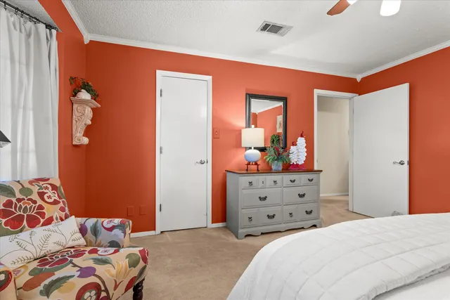 a bedroom with a bed and a dresser in it