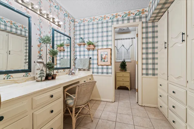 a spacious bathroom with a double vanity sink a mirror and a shower