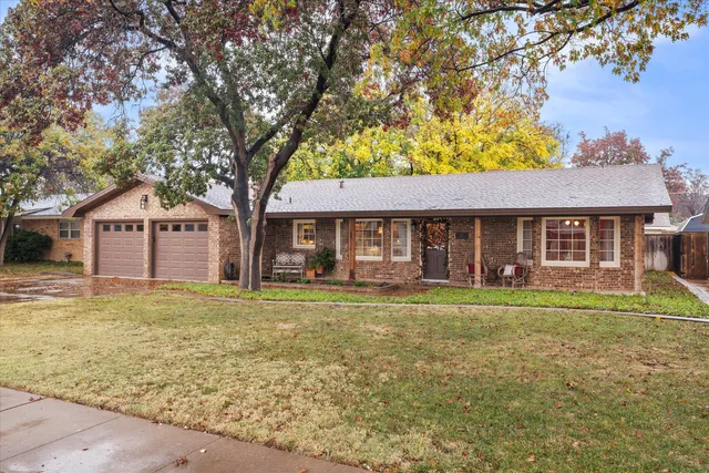 a front view of a house with a garden and porch