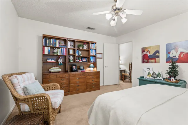 a bed room with a bed and a chair