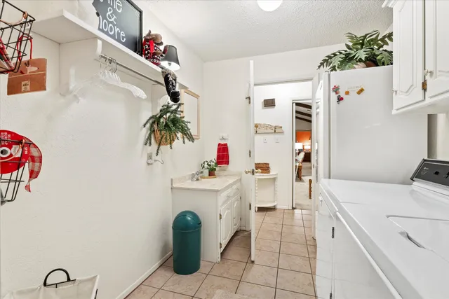 a utility room with sink dryer and washer