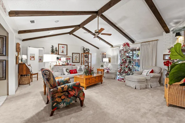 a living room with furniture and flowers