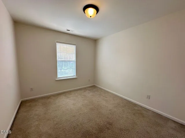 an empty room with closet area