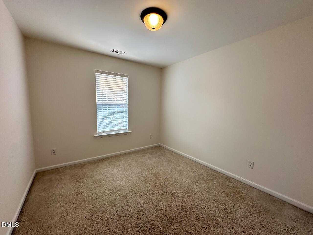 5413 Kissimmee Lane Raleigh, NC 27616 - Photo 19 of 26 an empty room with a window