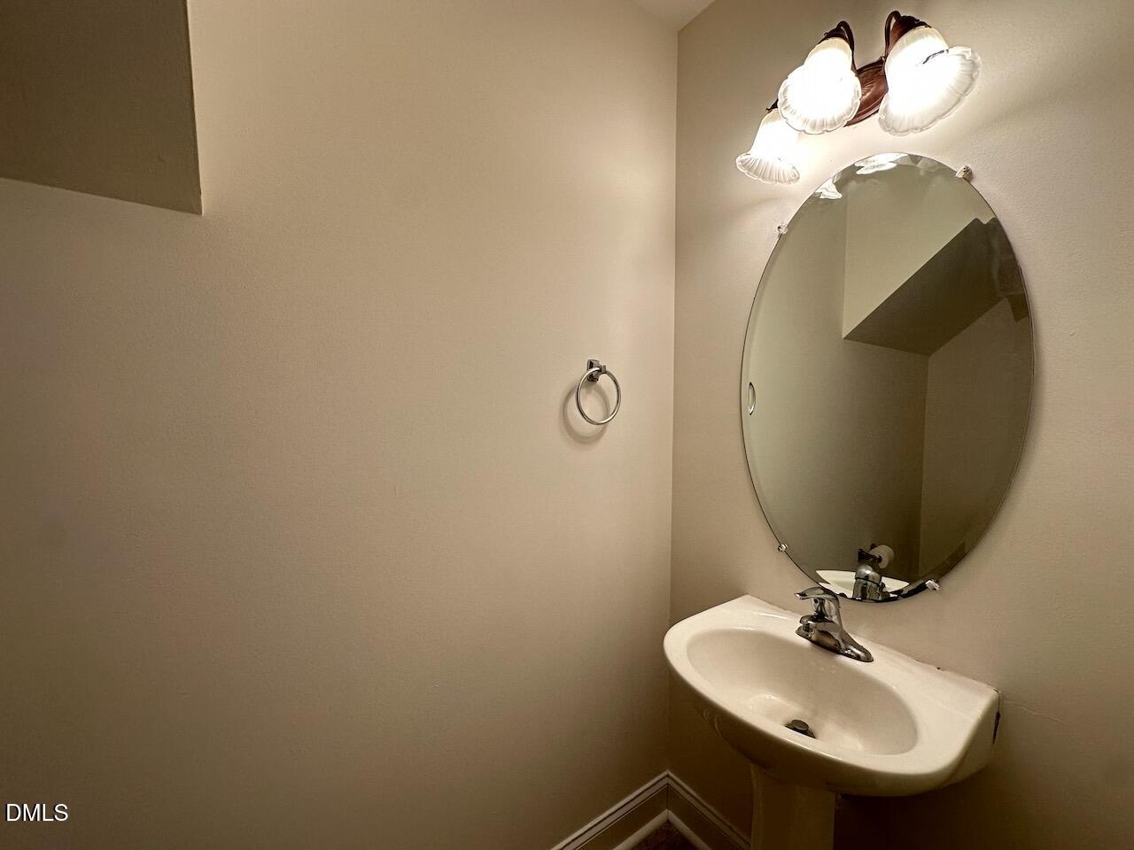 5413 Kissimmee Lane Raleigh, NC 27616 - Photo 23 of 26 a bathroom with a sink and a mirror