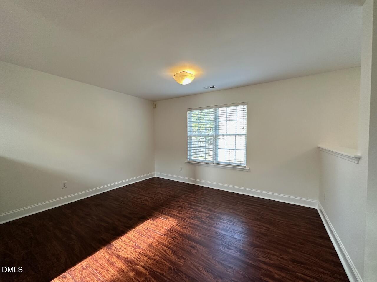 5413 Kissimmee Lane Raleigh, NC 27616 - Photo 5 of 26 wooden floor in an empty room with a window