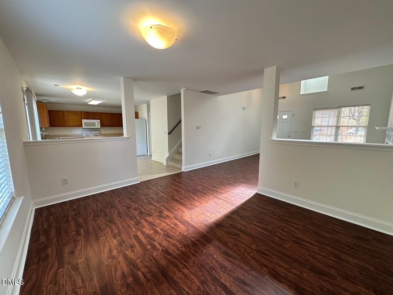 5413 Kissimmee Lane Raleigh, NC 27616 - Photo 7 of 26 an empty room with wooden floor and windows