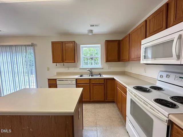 a kitchen with a stove a sink and a microwave