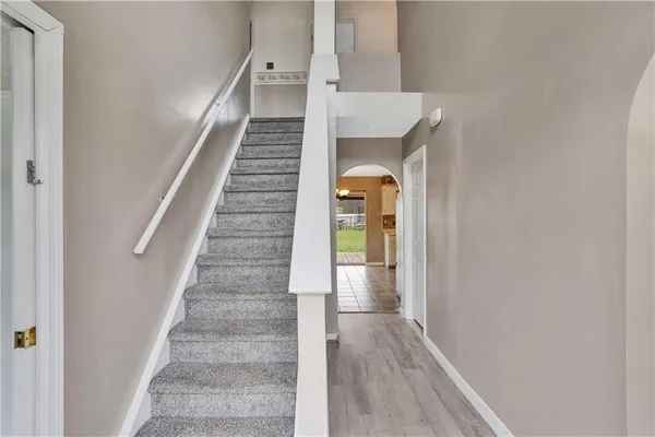 a view of entryway and hall with wooden floor
