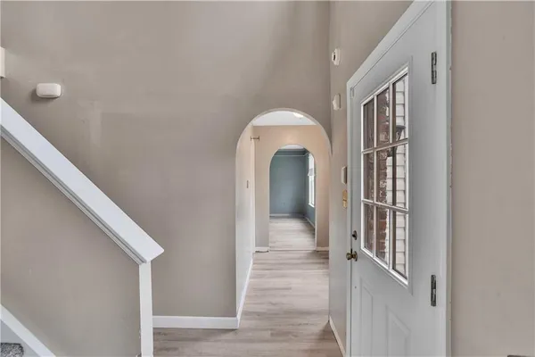 a view of entryway and hall with wooden floor