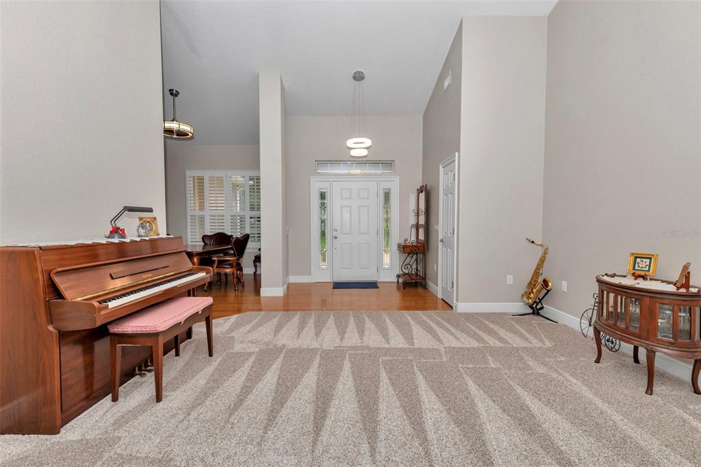 1989 Northwest 111th Loop Ocala, FL 34475 - Photo 10 of 55 a living room with a piano and wooden floor