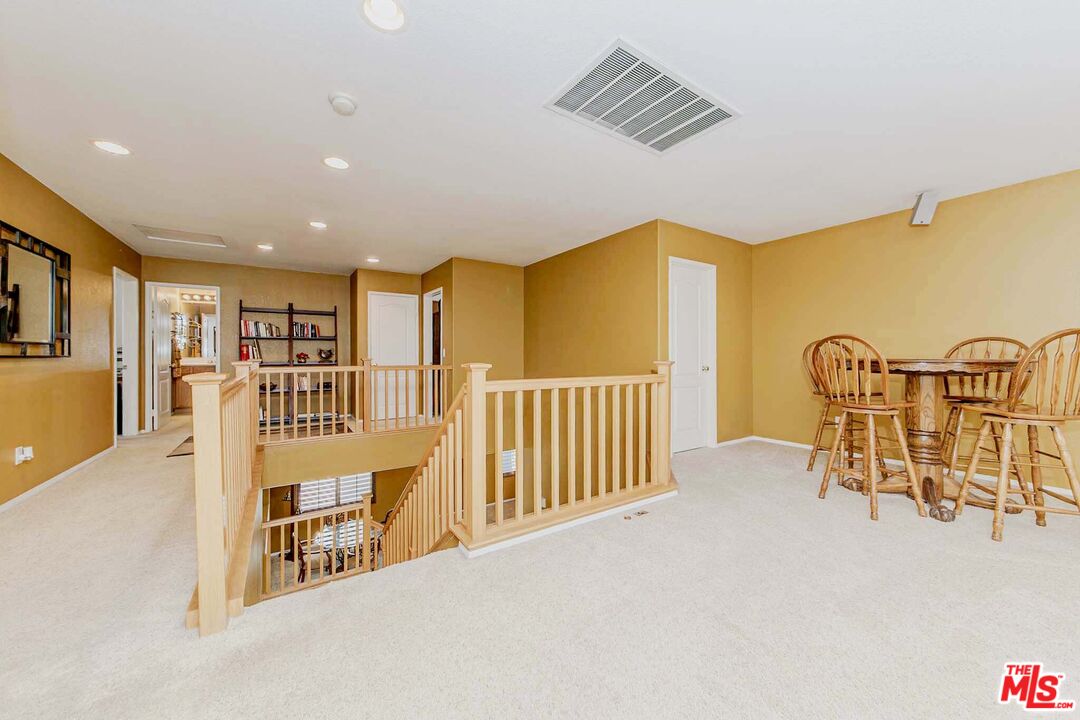 11318 Fitzpatrick Drive Rancho Cucamonga, CA 91730 - Photo 12 of 24 a view of a hallway with wooden floor and furniture
