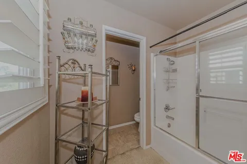 a bathroom with a shower and a sink