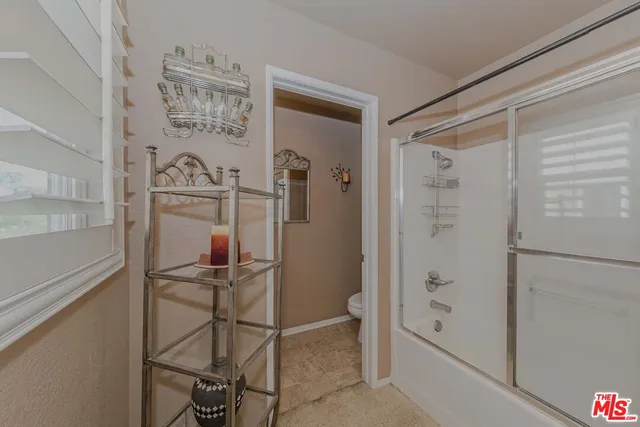 a bathroom with a shower and a sink