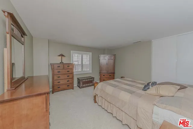 a bedroom with a bed and dresser