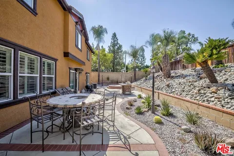 a view of a patio with table and chairs and potted plants