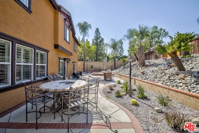 a view of a patio with table and chairs and potted plants