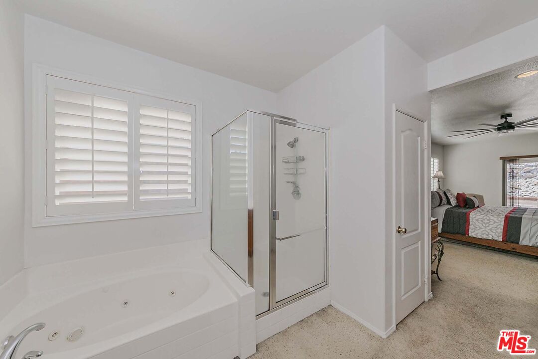 11318 Fitzpatrick Drive Rancho Cucamonga, CA 91730 - Photo 9 of 24 a bathroom with a bathtub shower and a sink