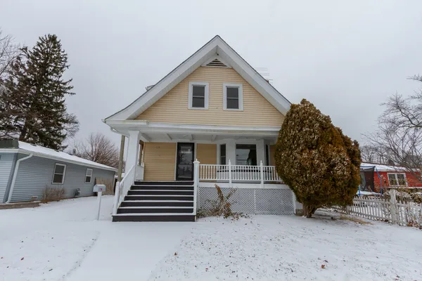a view of a house with a yard and garage