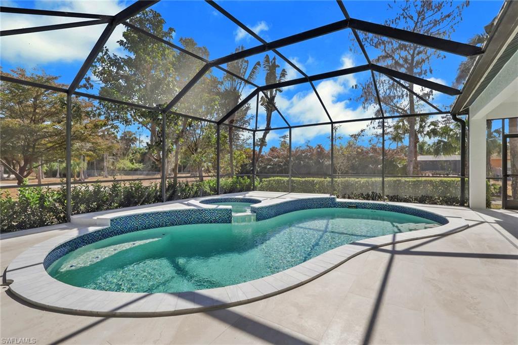 730 29th Street Southwest Naples, FL 34117 - Photo 40 of 50 Integrated pool / spa featuring a sunroom, glass enclosure, and a patio area