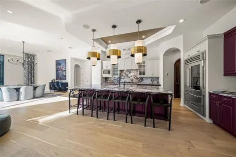 a large kitchen with stainless steel appliances granite countertop a large stove a sink dishwasher and cabinets with wooden floor