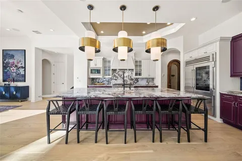 a large kitchen with granite countertop a lot of counter space and a sink