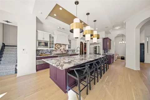 a kitchen with a sink refrigerator and cabinets