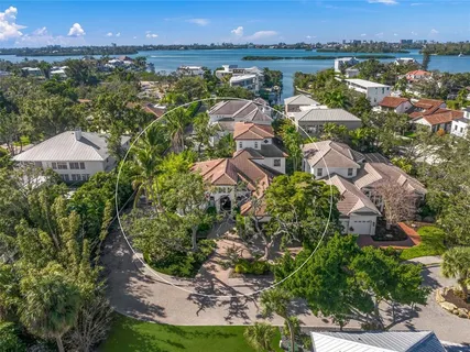 an aerial view of residential houses with outdoor space and trees