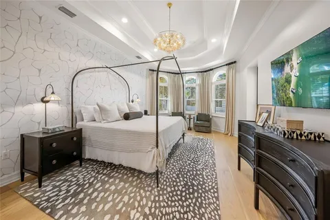 a bedroom with a large bed and a window