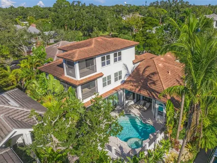 an aerial view of a house with garden space and street view