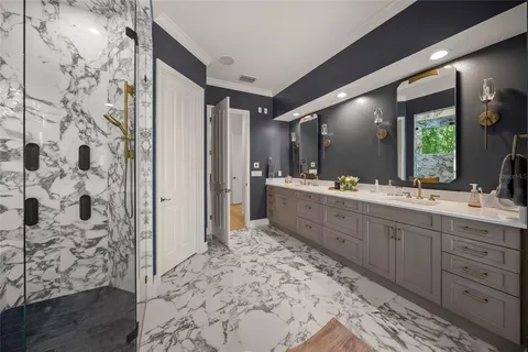 a spacious bathroom with a double vanity sink a mirror and toilet
