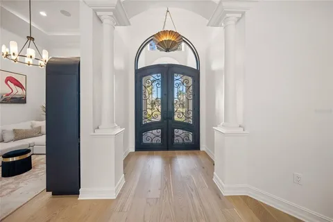 a living room with furniture and a chandelier