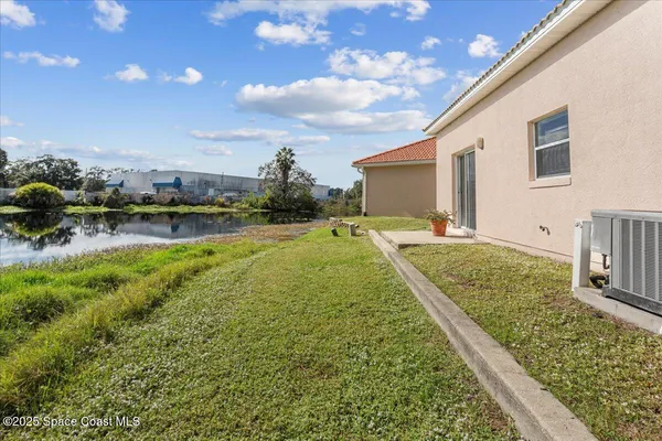 a view of a house with a yard and sitting area